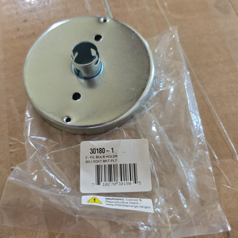 Metal component on a cardboard surface with a clear plastic wrap