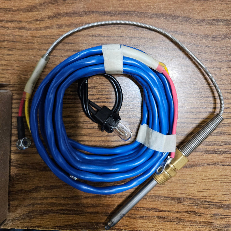 Coiled blue cable with metal probe on a wooden surface